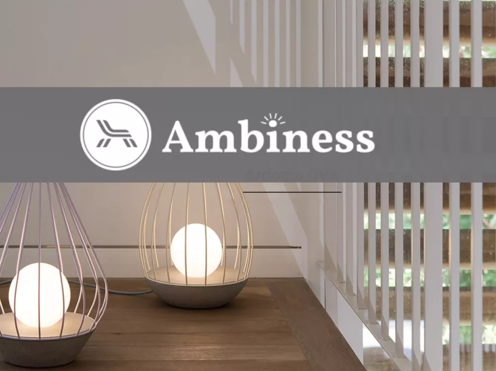 The Ambiness logo in front of a staircase illuminated by two lights. 