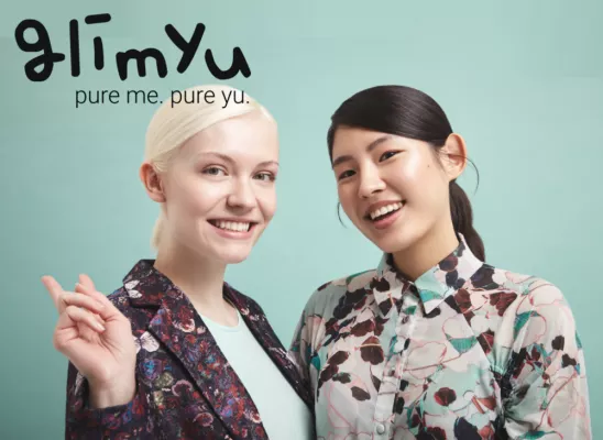 Two models and the black inscription “glimyu” with the subtitle “pure me. pure yu.”