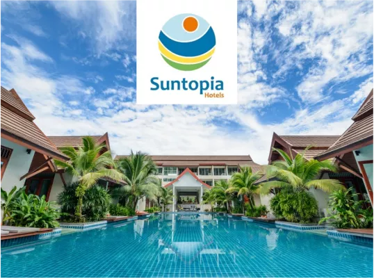 A hotel landscape with palm trees and the Suntopia logo above it. 